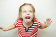 © Ilshat - Angry little girl shows her tongue in funny grimace