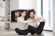 © .shock - multiethnic couple using tablet computer in front of fireplace