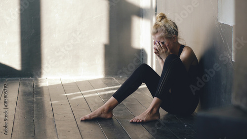 Cuadros en Lienzo Closeup of young teenage girl dancer crying after loss perfomance sits on floor