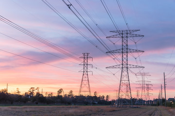 Wall Mural - Industrial background group silhouette of transmission towers (or power tower, electricity pylon, steel lattice tower) at bloody red sunset. Texture of high voltage pillar, overhead power line at dusk