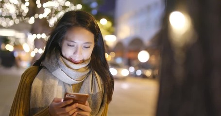 Poster - Woman working on smart phone in the city at night