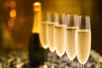 Many glasses of champagne in a line. Selective focus