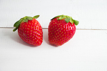 The red strawberry,Fresh fruit, put on wooden  timber board,blurry light around.healty fruit and good for life.