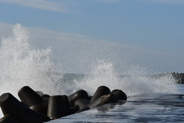 Wall Mural - Wave splash and tetrapods