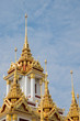 Golden Spires Against Blue Sky at Loha Prasart Buddhist temple complex