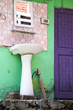 Colorful Outdoor Pedestal Sink and Mirror with Purple Bathroom Door in Tosh, India