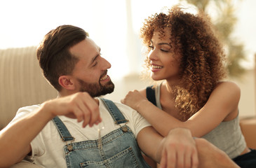 Young couple sitting on couch in new apartment