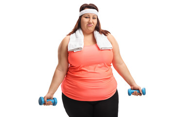 Poster - Tired overweight woman with small dumbbells and a towel