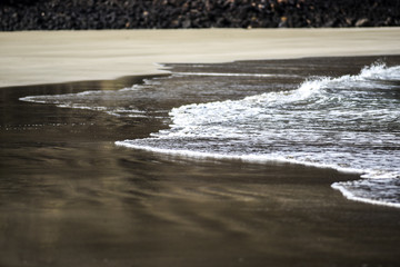 Ocean wave on the clear sand, Canary Islands, Lanzarote.