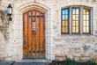 © dr_verner - Wooden door and window on the stone facade of historic building, Atlanta, USA