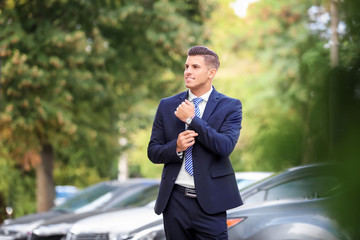 Wall Mural - Attractive man in formal suit on city street