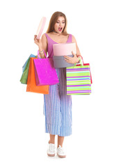 Poster - Excited young woman with shopping bags and boxes on white background