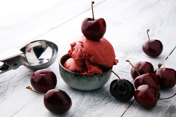 Poster - Homemade cherry ice cream on wooden background with fresh cherries