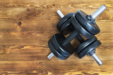 Wall Mural - Top view of a dumbbells on a wooden background in a gym, health lifestyle concept