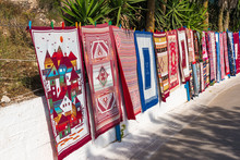 Large Selection Of Handmade Colorful Carpets Offered For Sale On Street In Anafonitria On Zakynthos Island In Greece. Carpets Are Very Popular Souvenirs From Zakynthos.