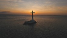 Aerial View Sunken Cemetery Cross At Sunset In Camiguin Island, Philippines. Large Crucafix Marking The Underwater Sunken Cemetary Of The Coast Of Camiguin Island Near Mindanao In The Philippines