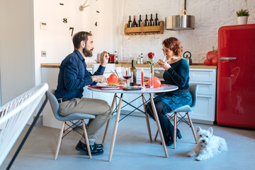 Mature couple having a romantic dinner at home for valentine’s day .