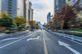 Fototapeta  - blurred asphalt road through modern city in China