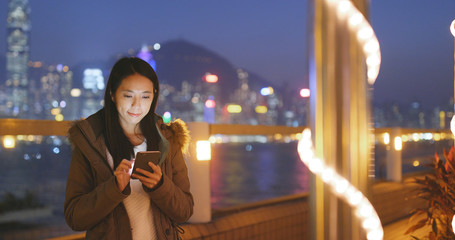 Poster - Woman use of mobile phone in the city at night