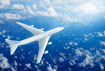 Wall Mural - airplane flying above clouds