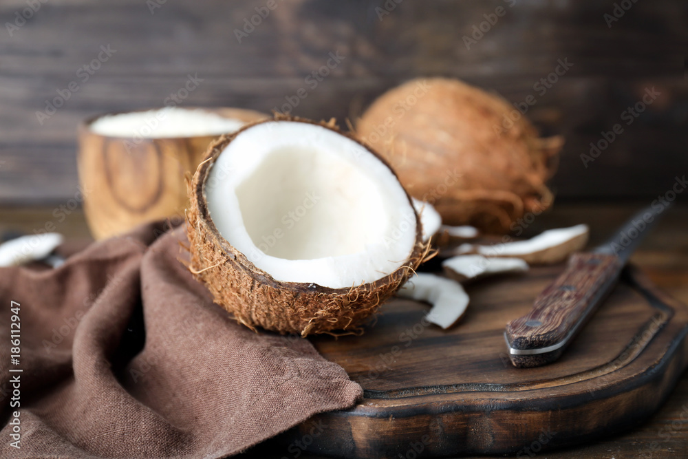 Composition with half of coconut on wooden board