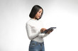 © SOMPHOTO - Beautiful asian woman holding tablet with isolated white background
