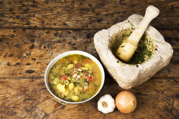 Bowl of pistou soup on an old wooden table