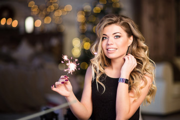 young beautiful girl smiles and holds bengal lights