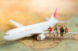 © polymanu - Miniature business people : businesses team waiting for airplane with copy space for travel around the world, business trip traveler adviser agency or online world wide marketing concept.