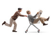 © Ljupco Smokovski - Senior pushing a shopping cart with another senior with a newspaper riding inside