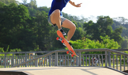 Wall Mural - female skateboarder legs skateboarding at skatepark