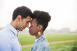 © Myroslava - Side view of young romantic couple who standing with closed eyes face to face outdoors'