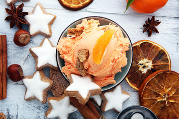 Wall Mural - Winter Ice cream with gingerbread and tangerines, on wooden background