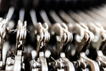 Antique typewriter mechanical typebar slide. Each key connects to a lever that when pressed, moves a type bar that presses ink to a page I