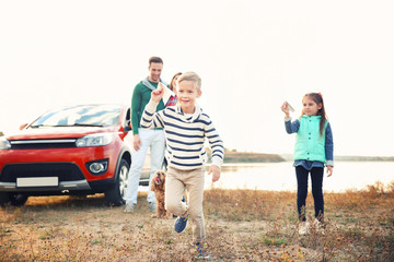 Sticker - Cute children playing and parents near car, outdoors