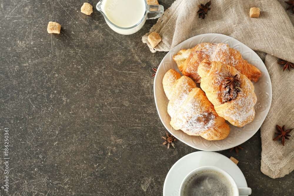 Composition with tasty croissants, milk and coffee on table