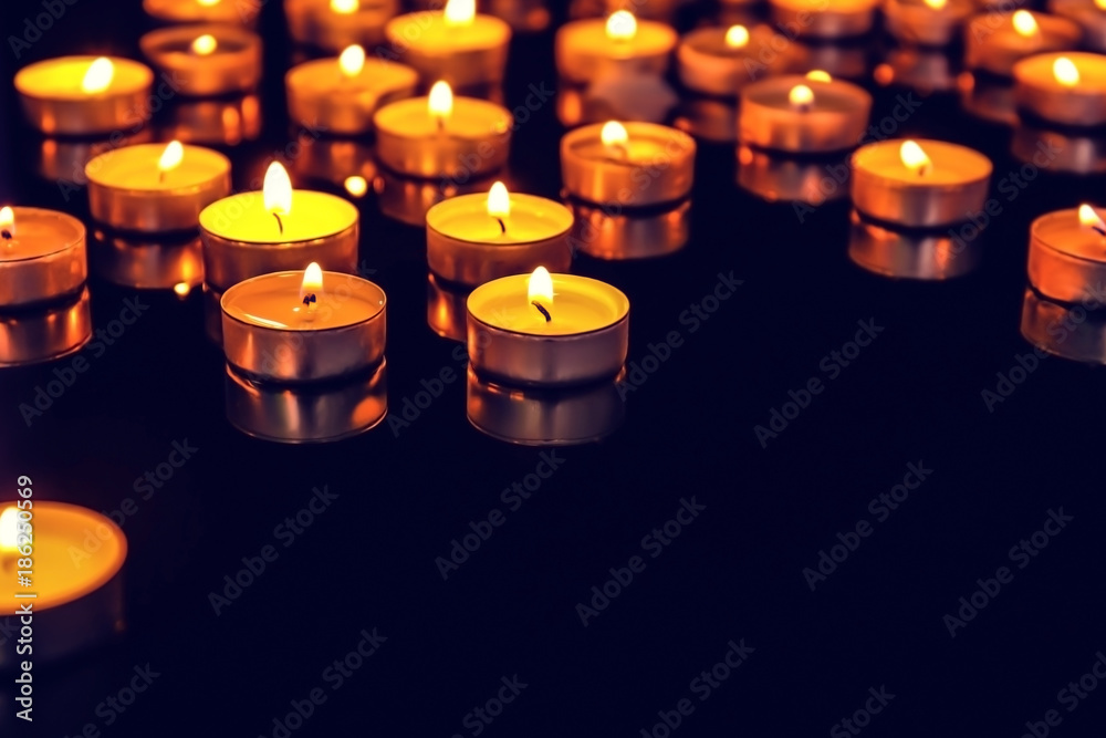 Burning candles on dark background