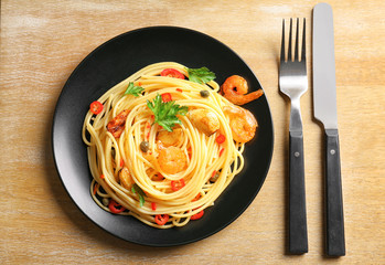 Sticker - Delicious pasta with garlic and fried shrimps on plate