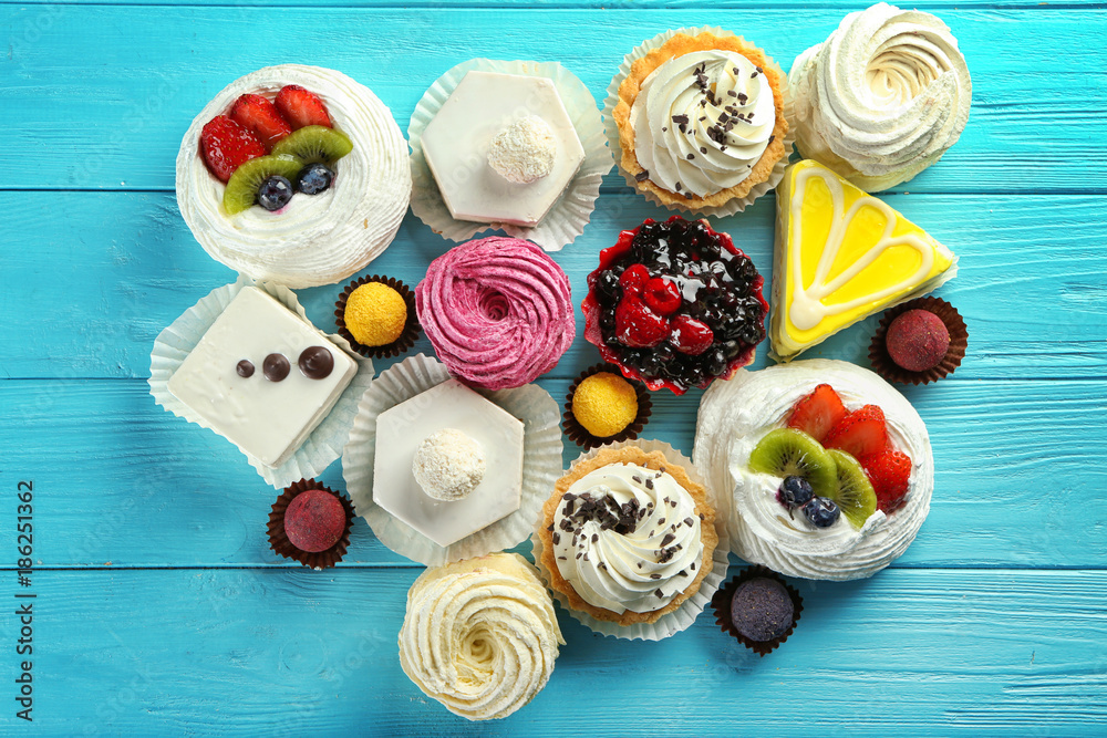 Assortment of tasty sweets on wooden background