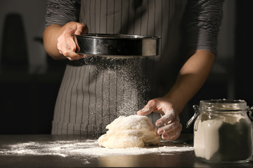 Wall Mural - Woman making dough on table