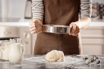 Wall Mural - Woman making dough on table