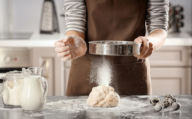 Wall Mural - Woman making dough on table