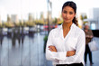 © elnariz - Serious career motivated successful female business professional standing proud and confident near downtown financial buildings