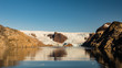 © Dylan Lee - Glacier Wrapping Around Rocky Outcropping in Prince Christian Sound Greenland