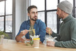 © wayhome.studio  - Portrait of two male colleagues have informal meeting at office, eat noodle with chopsticks and fresh vegeterian salad, have lunch at working place, discuss main issues of work. Partner`s parley