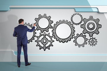 Poster - Businessman drawing gears sketch on a board 3D rendering