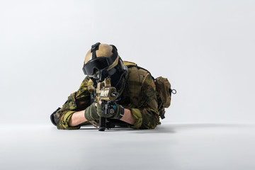 Defender watching at special weapon while lying on ground. Military concept