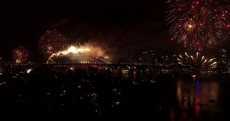 Sticker - New year 2018 fireworks in Sydney at night over city CBD landmarks reflecting in still waters of Harbour slow panning view.
