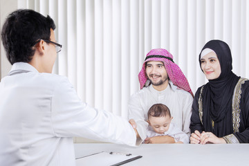 Wall Mural - Arab family visiting a pediatrician