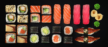 Japanese Cuisine. Sushi And Rolls Set Over Dark Background.